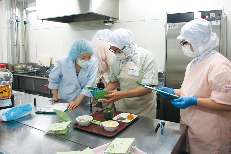 写真：調理場で食事を確認する様子