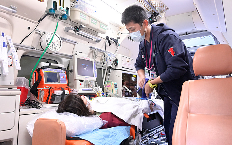 写真:救急車の中で処置を行う看護師